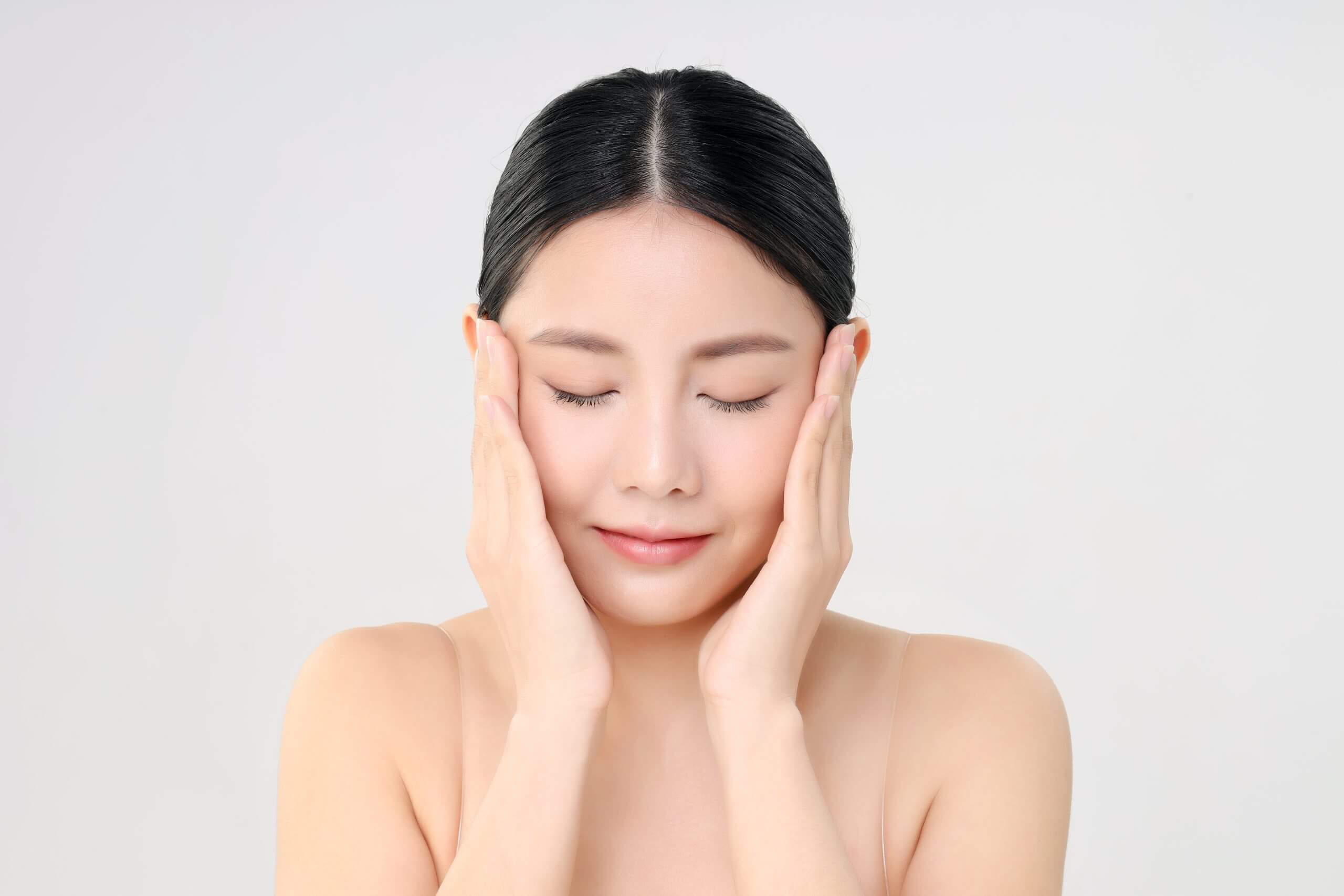 Beautiful Face Of Young Adult Asian Woman With Clean Fresh Skin.